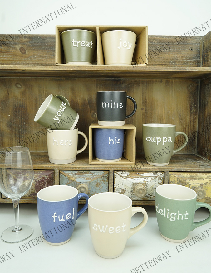 Stoneware coffee mug matte reactive glaze with embossed white words