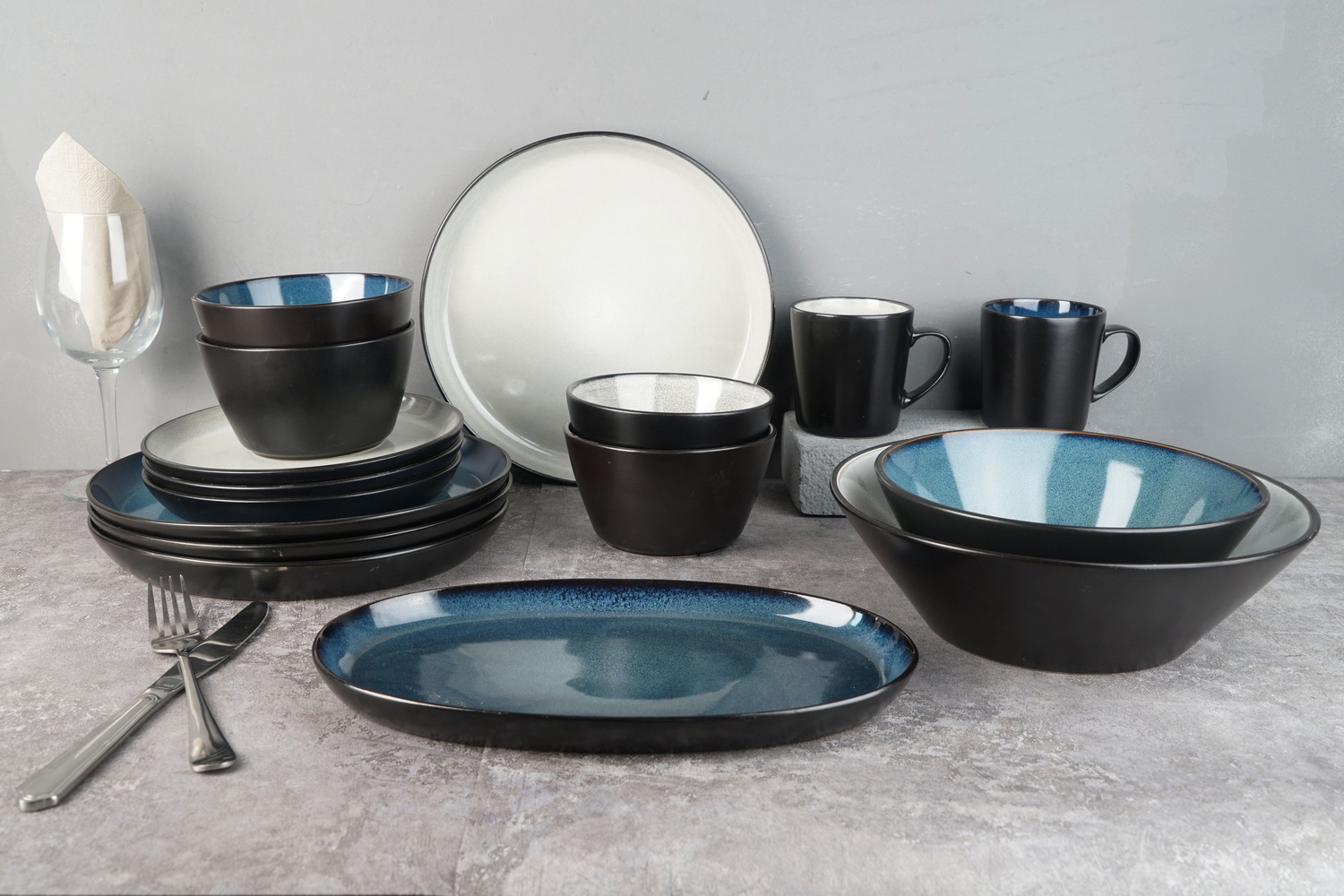 Stoneware dinnerware inside with reactive glaze outside matte black